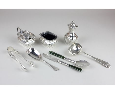 A George V silver cruet, a Victorian silver caddy spoon, a silver cheese scoop, sugar tongs and a spinach jade handled butter