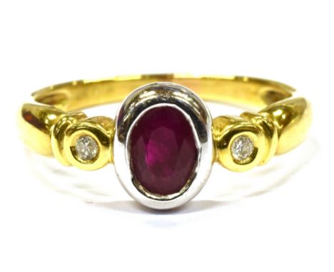 A RUBY AND DIAMOND THREE STONE 18CT GOLD RING the oval cut ruby approx. 7 x 5mm, with two small round cut diamonds, rub over 