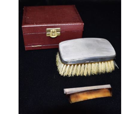 A GENTLEMAN BOXED GARRARD SILVER BRUSH AND COMB With engine turned finish, the brush 11cms x 6cms with small silver topped co