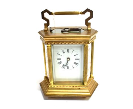 A BRASS CASED CARRIAGE CLOCK  of hexagonal form, the shaped sides with enamelled decoration of cherubs, enamel dial with Roma