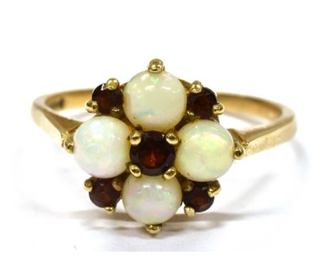 AN OPAL AND GARNET CLUSTER 9CT GOLD DRESS RING the cluster comprising four round white opals and five small round cut garnets