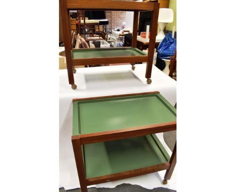 TWO 1970S MAHOGANY FRAMED TWO TIER TROLLEYS  each with lift-out green plastic trays 75cm x 40cm, the frames stamped with mili