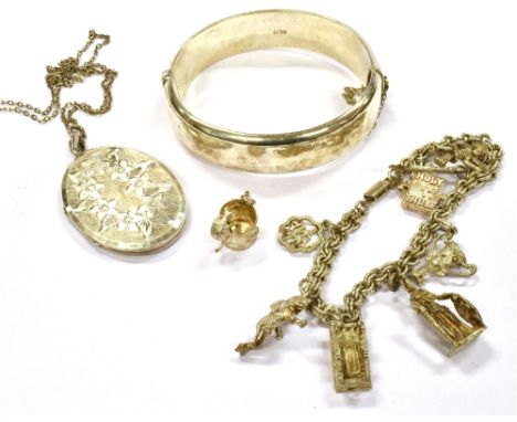THREE ITEMS OF SILVER JEWELLERY  Comprising a charm bracelet with eight charms and two loose charms, a hollow hinged bangle a
