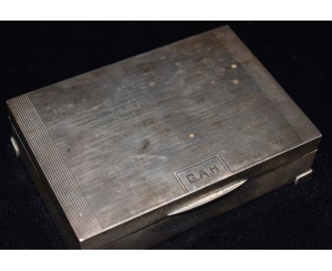AN ART DECO SILVER CIGARETTE BOX By Goldsmiths and Silversmiths Co, engine turned decoration to hinged lid initialled G.A.H. 