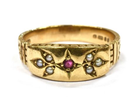 A MODERN 9CT GOLD SMALL RUBY AND SEED PEARL SET BAND RING the bead set front all in one to yellow gold shank, hallmarked 1977