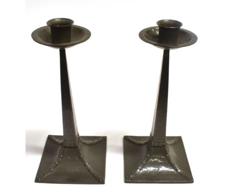 A PAIR OF JAMES DIXON PEWTER CANDLESTICKS IN THE MANNER OF LIBERTY with hammed and strapwork decoration, marked to base 'W183
