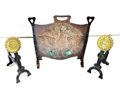 AN ARTS AND CRAFTS STYLE WROUGHT IRON AND COPPER FIRESCREEN with embossed decoration of a peacock, and enamel Ruskin style ro