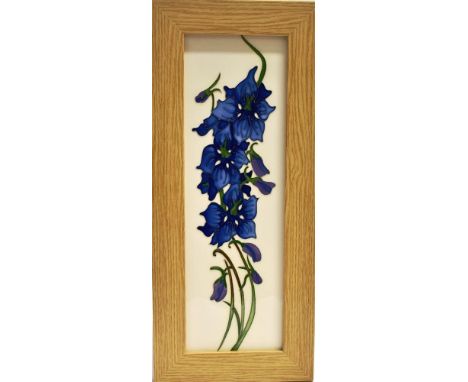 A MOORCROFT POTTERY PLAQUE DECORATED WITH THE 'DELPHINIUM' PATTERN  designed by Kerry Goodwin, in light oak frame, dated 2015