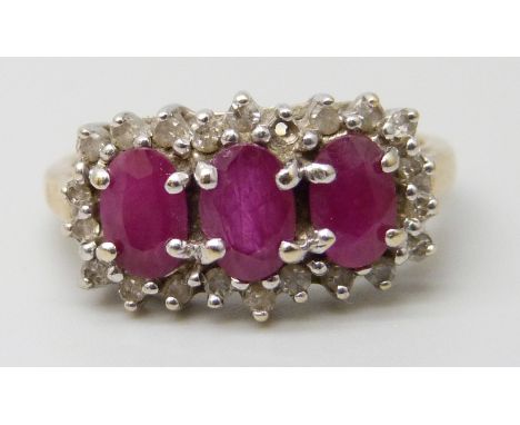 A 9ct gold, three stone ruby and diamond cluster ring, 3.2g, M