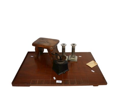 Coffee grinder, plated candlesticks, shove penny board, and a rustic stool 