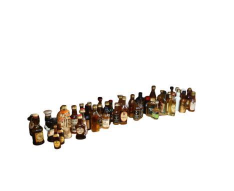 A large quantity of alcoholic miniatures, including Scotch, Guinness, Vodka, Whisky etc, novelty titles such as Cripple Cock 