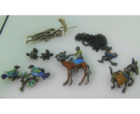 A silver and marcasite Brooch of an Art Deco lady walking a dog, together with three silver and enamel brooches, a pair of ma