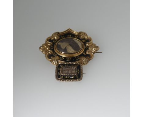 A 19thC black enamel Mourning Brooch, of diamond shape with scrolling border, black enamel panel marked 'In Memory Of', the c