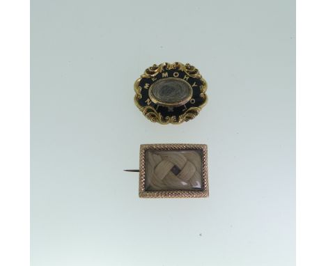 A gold plated 19thC Mourning Brooch, of shaped oval form with black enamel and 'In Memory Of' lettering, the centre hair set,