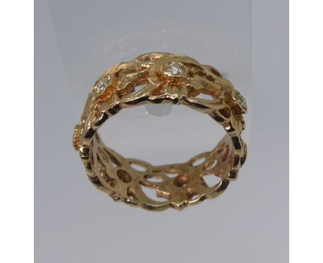 Stuart Devlin; 'The Welsh Gold Eternity Ring', with import marks for London, 1987, in 14ct gold of pierced foliate design set