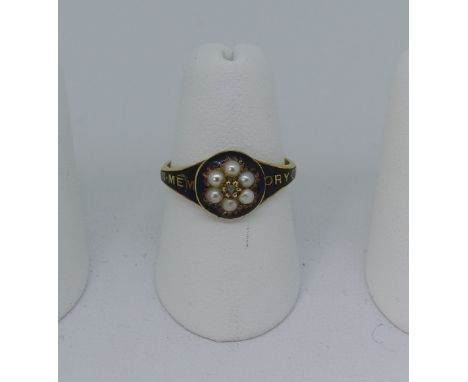 A Victorian 18ct gold and black enamel Mourning Ring, the circular front set with a seed pearl cluster and diamond point cent