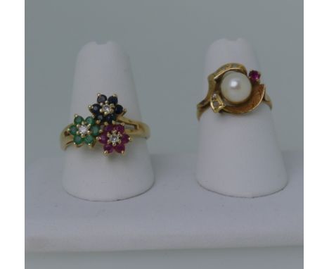 A 14ct yellow gold multi gem set Ring, formed of sapphire, ruby and emerald flowerheads each with diamond point centres, Size