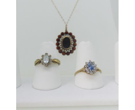 A late 19thC garnet and seed pearl Pendant Locket,&nbsp;the central oval box and glass within a surround of seed pearls and o