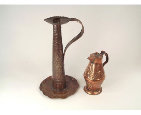 CORNISH ART COPPER. An Arts &amp; Crafts tall copper chamber stick, the drip pan with two repoussé fish. Height 29cm. Also, a