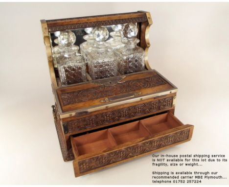 TANTALUS. A High Victorian oak tantalus, with mirrored back, &amp; silver plated mounts. The fall front revealing a small gam