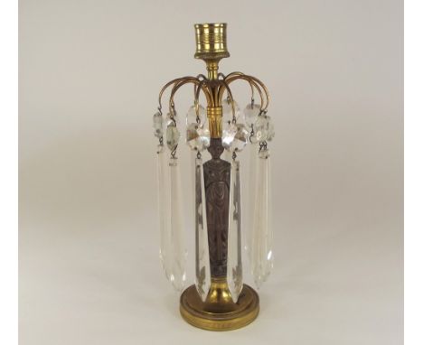 CANDLESTICK LUSTRE. A single brass & bronzed metal figural candlestick, hung with glass lustre drops. Height 25cm.