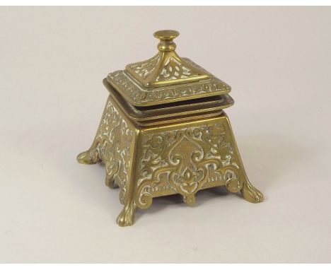 INKWELL. A cast brass inkwell. Height 11cm.