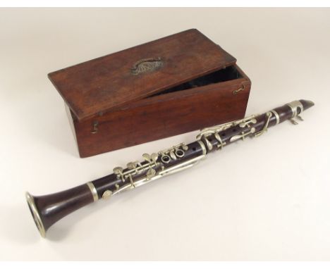 CLARINET. A rosewood clarinet with nickel mounts, in mahogany fitted box. Length 56.5cm.