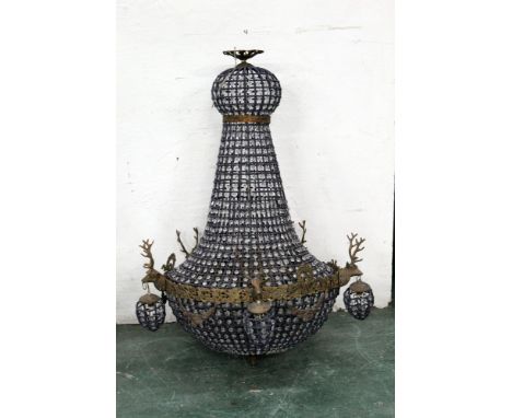 A large chandelier decorated with five stags heads.  Height +/- 107 cm, diameter +/- 63 cm. 