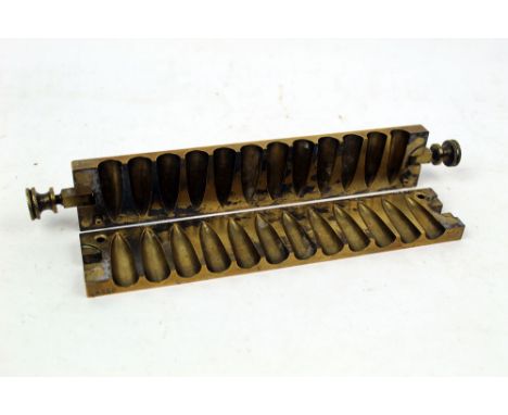 A brass bullet mould, marked to the rear S &amp; R and Segaud Courbevoie (Seine), marked to the top C4226.  Length 21.5 cm, h