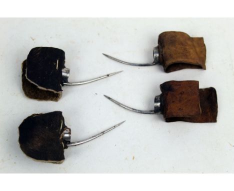 Two pairs of vintage cock fighting spurs, first with light brown leather straps with 5 cm spurs, the second with dark brown l