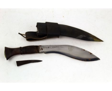 A World War II Ghurka Kukri knife, blade marked Gorkha Army 1945 with wooden handle, brass pommel with Ghurka motif, the leat