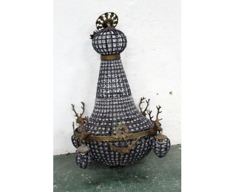 A chandelier decorated with four stags heads.  Height +/- 93 cm, diameter +/- 47 cm. (AF)