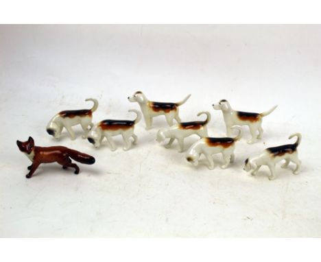 Seven Beswick first version foxhounds and a fox.