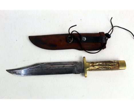 A mid 20th century Bowie knife, having a 10" blade with brass pommel and hilt, with stag antler grips.  Overall length 41 cm 