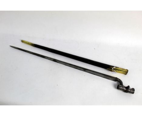 A socket bayonet for a Martini Henry rifle, circa 1853, the scabbard and bayonet both with War Department broad arrows.