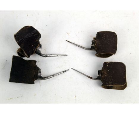Two pairs of vintage cock fighting spurs, first of slender form and having  4 cm spurs, the second heavy gauge with 4 cm spur