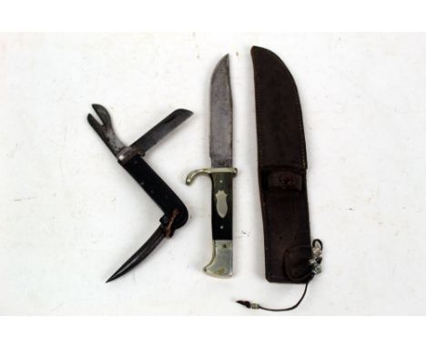 A military Jack knife, stamped with a broad arrow and dated 1940, together with J Weiss & Son Sheffield, a fixed blade knife 