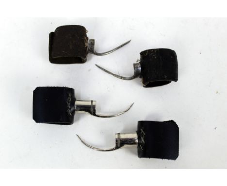 Two pairs of cock fighting spurs, first set marked Sunset 9309 L and R, with 1 3/4" spurs, the second pair marked internally 