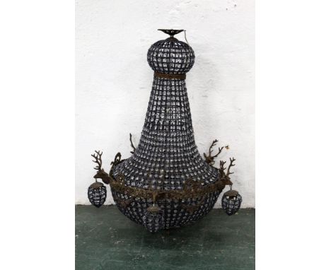 A large chandelier decorated with five stags heads.  Height +/- 107 cm, diameter +/- 63 cm. 