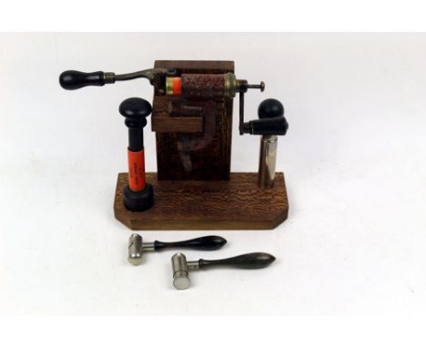 A shotgun cartridge loading tools display, with a roll turnover machine, together with two horn handled powder measures, one 