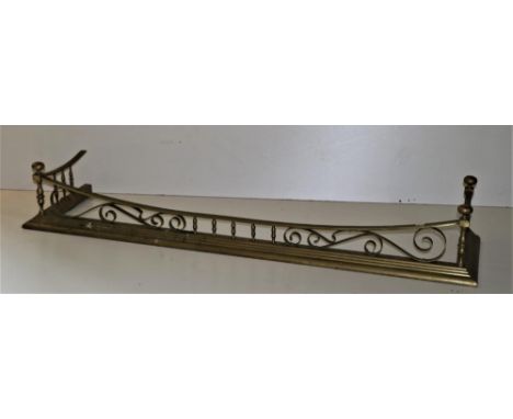 An Edwardian brass Fire Curb, with pillar supports and scroll design on step plinth base, 150cms (59") wide. (1) 