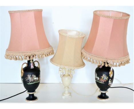 A good pair of Grecian style porcelain black ground vase shaped Table Lamps, each with two leaf scroll handles and decorated 