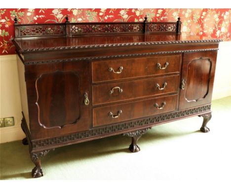 A Chippendale style carved mahogany Sideboard, with fretwork back rail, three long centre drawers flanked to either side by a