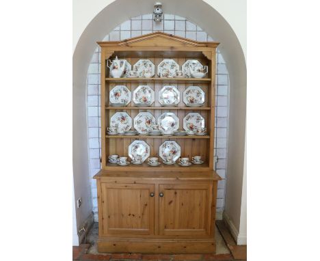 A good quality figured pine Dresser, the angled cornice over a four shelf open top, on a base with two doors, approx. 7'6" hi