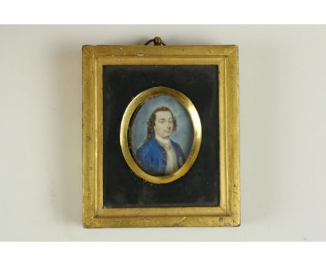 Late 18th Century Irish School&nbsp;A miniature oval Portrait "Gentleman in blue crested coat with black curly hair," in cont