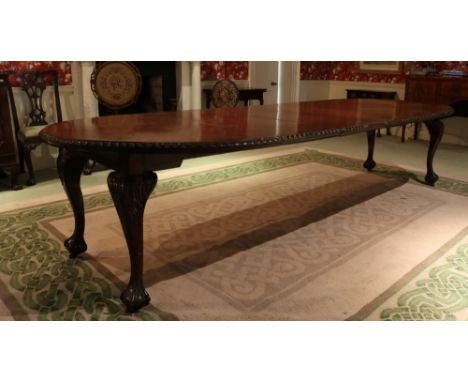 A large Chippendale style carved mahogany Dining Table, with gadroon edge and raised on four leaf carved cabriole legs with b