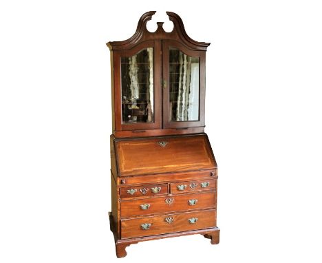 A fine quality Georgian period Irish mahogany&nbsp;Bureau Cabinet, the swan neck broken pediment with rosewood crossbanding, 