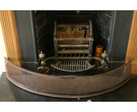 A Georgian style steel Basket Grate, with brass urn finials, 17cms (28")wide and a pierced steel bow fronted Fender, 117cms (