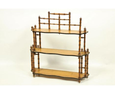 A Victorian three tier satin birch Wall Bracket, with serpentine shaped shelves and simulated bamboo rails, 25" (64cms). (1)P