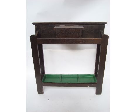 An early 20th Century oak umbrella/stick stand, with hinged compartment and green painted metal drip tray. 